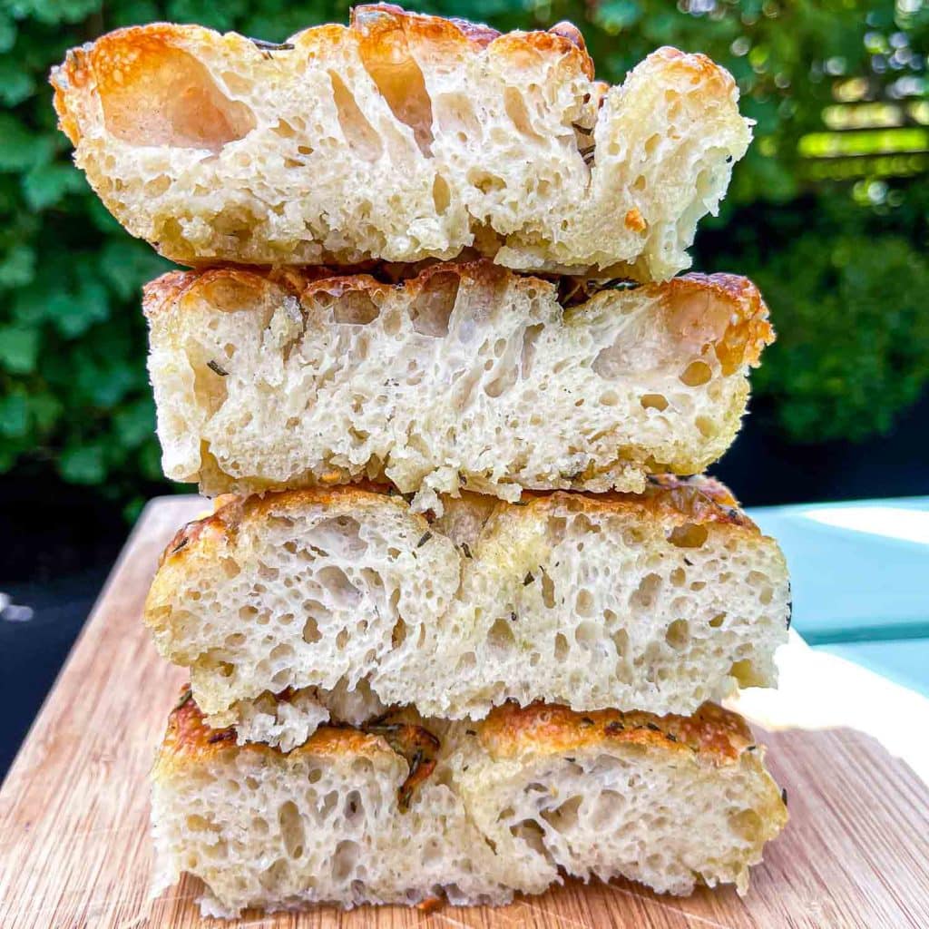 A stack of freshly-made no-knead foccacia slices.