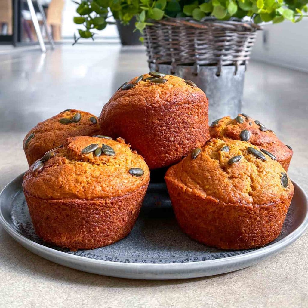 Fluffy pumpkin muffins, topped with pumpkin seeds.