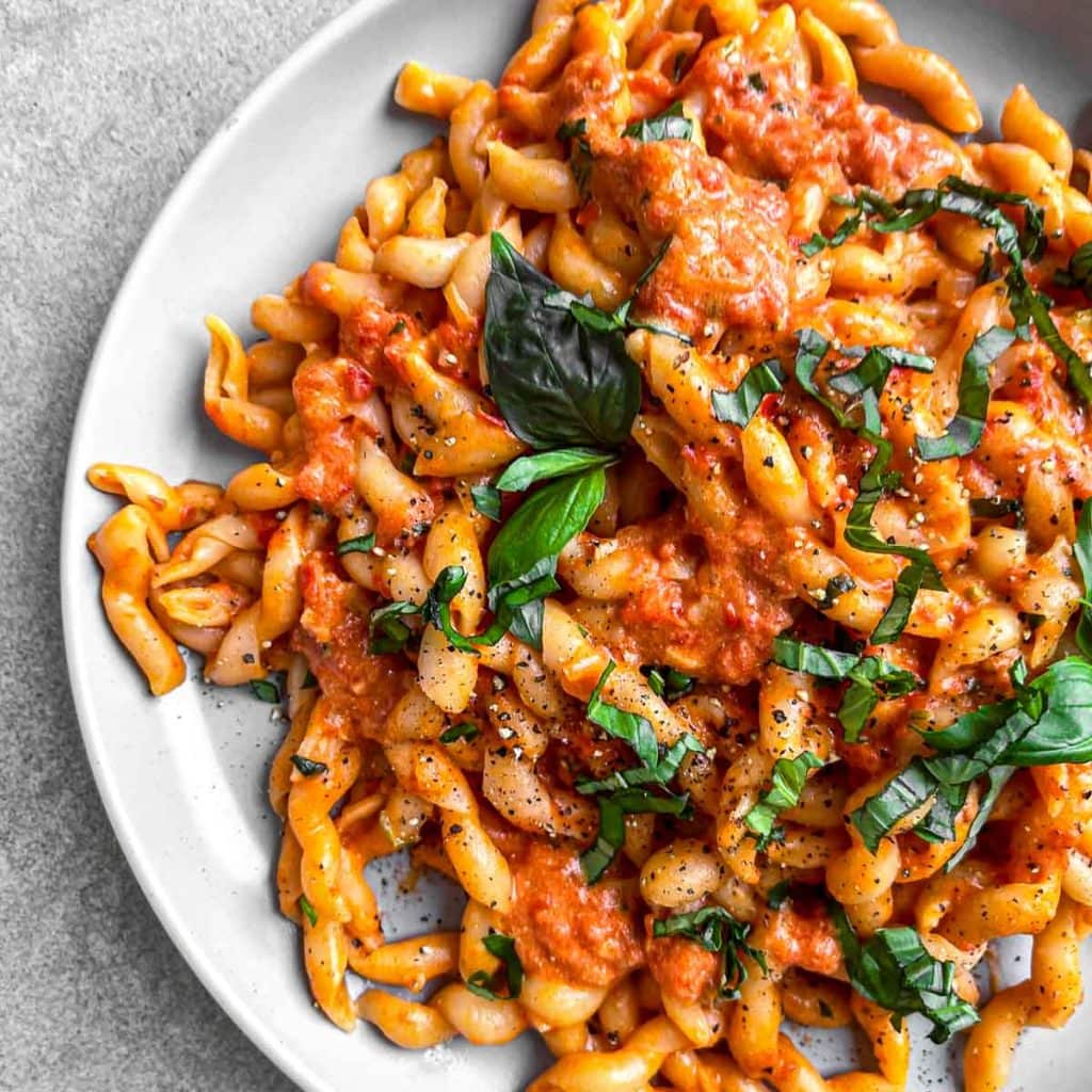 Creamy tomato pasta, topped with fresh basil.