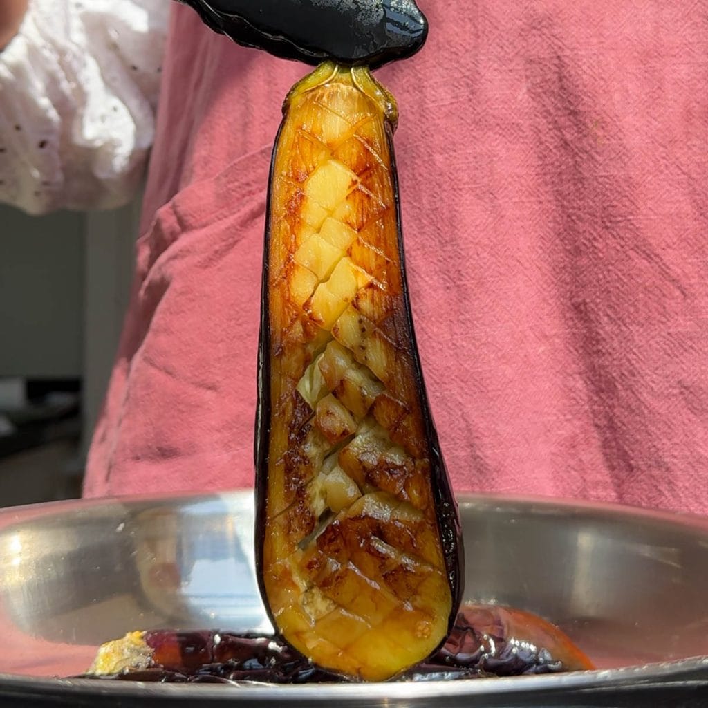 seared aubergines coming out of the pan