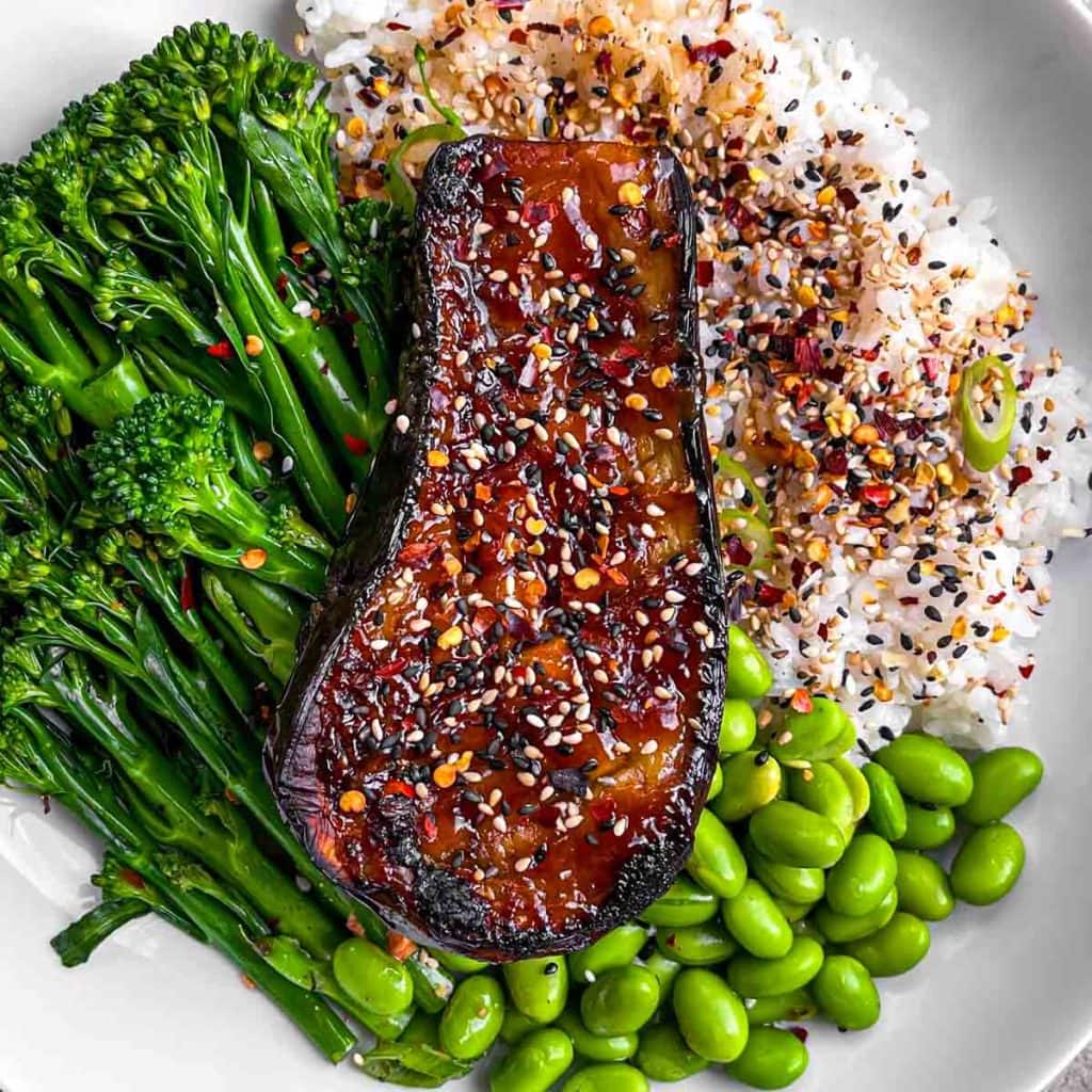 A closeup of the miso aubergine, served with rice and veggies.