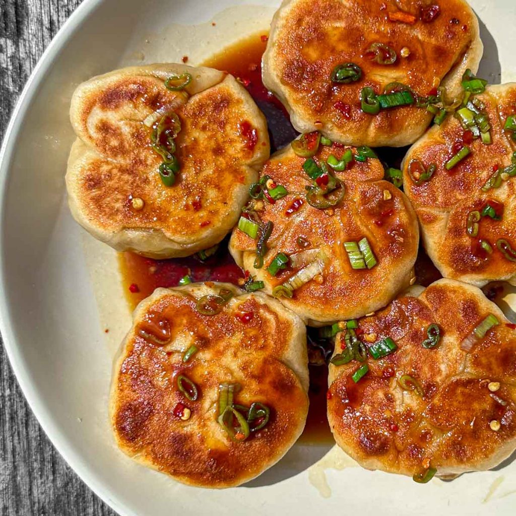 Crispy hoisin pork buns, served in a white bowl.