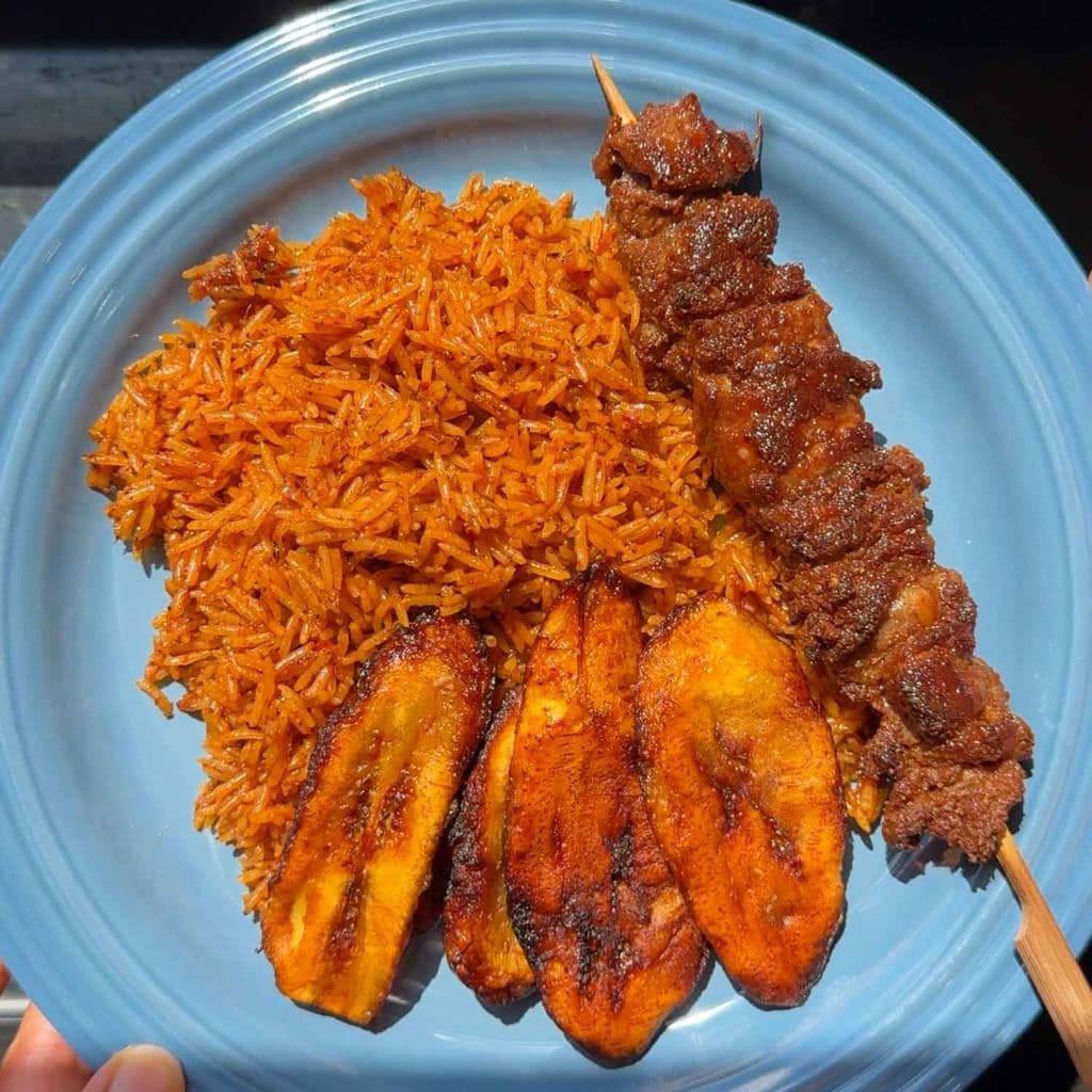 Jollof rice with beef soya and fried plantain.
