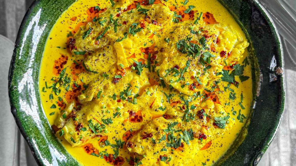 Cod fillets, poached in a coconut saffron broth.