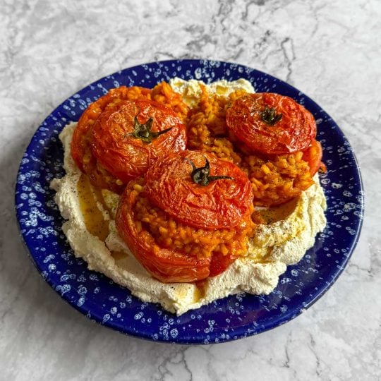 Rice stuffed tomatoes, served over whipped ricotta.