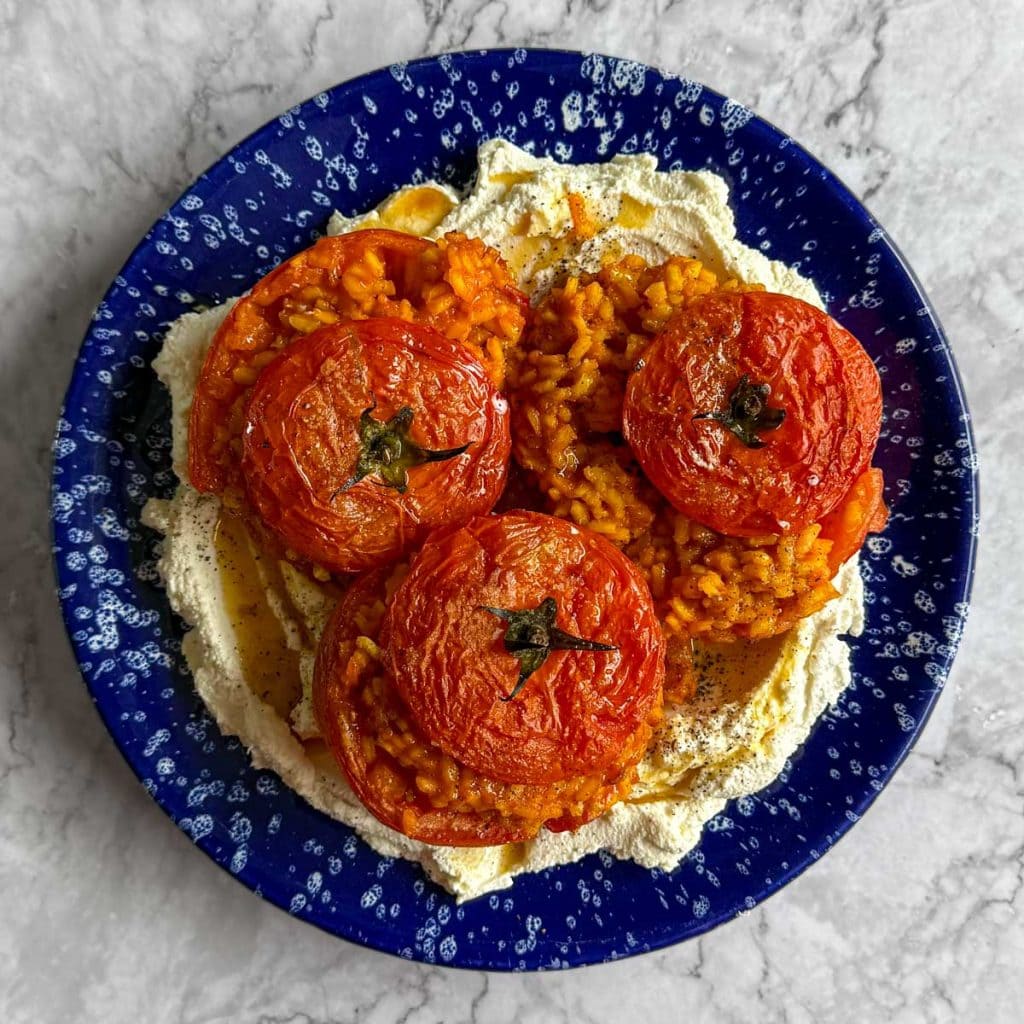 Rice stuffed tomatoes, served over whipped ricotta.