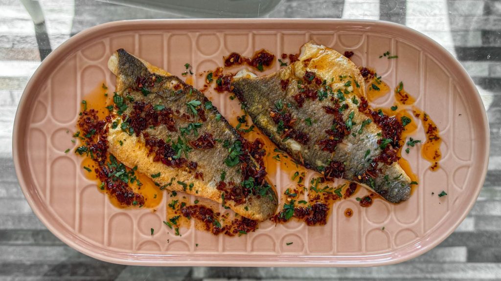 Crispy sea bass fillet topped with a spoonful of vibrant chilli and lemongrass sauce.