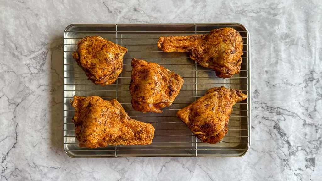 The chicken arranged in a single layer on a wire rack.