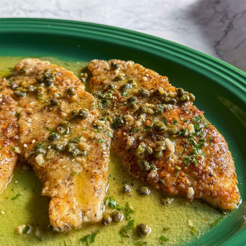 Close-up of Za’atar Fish Piccata with glossy lemon caper sauce and parsley