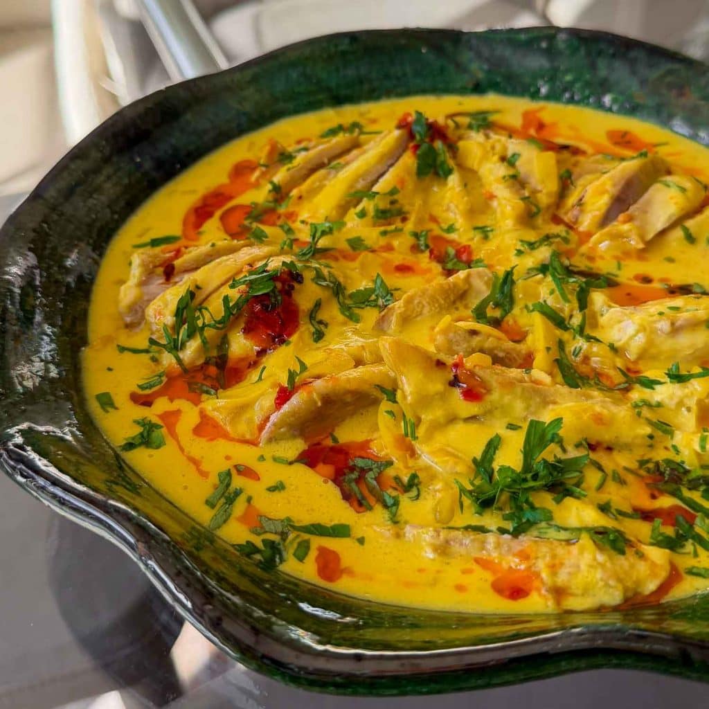 Chicken poached in a saffron coconut broth, finished with fresh coriander.