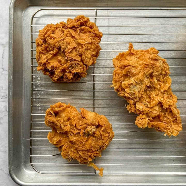 Lemongrass Fried Chicken cooling on rack after frying, showing perfect golden brown colour and texture.