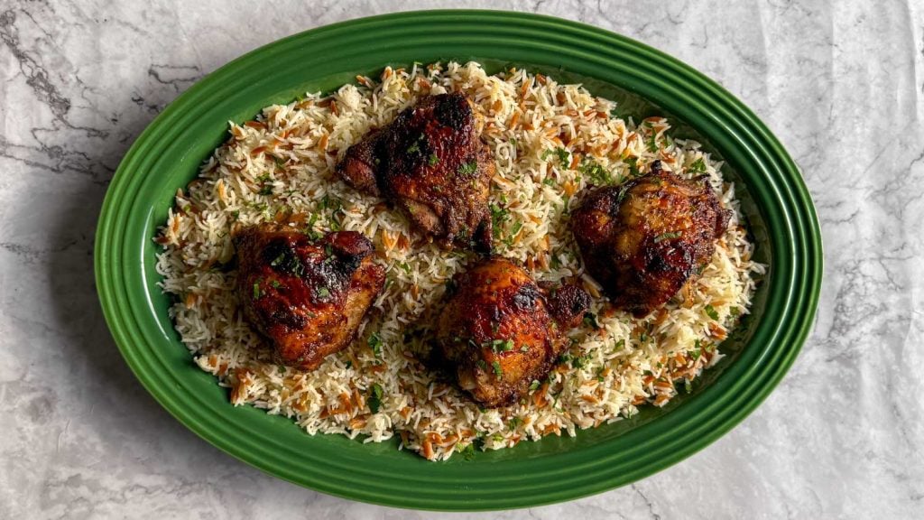 An overhead shot of Sticky sumac chicken, served over Lebanese-style rice.