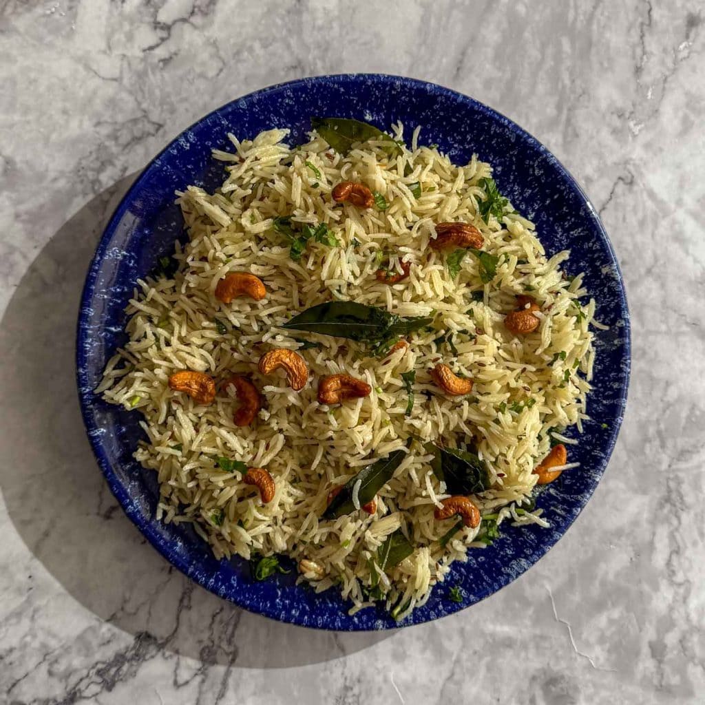 Spiced Curry Leaf Rice served on a blue plate, showing fluffy basmati rice with curry leaves.