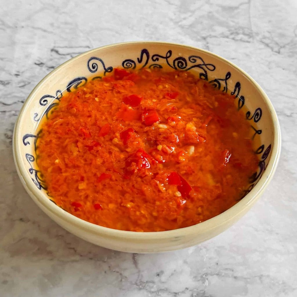 Homemade sambal, served in shallow white bowl.
