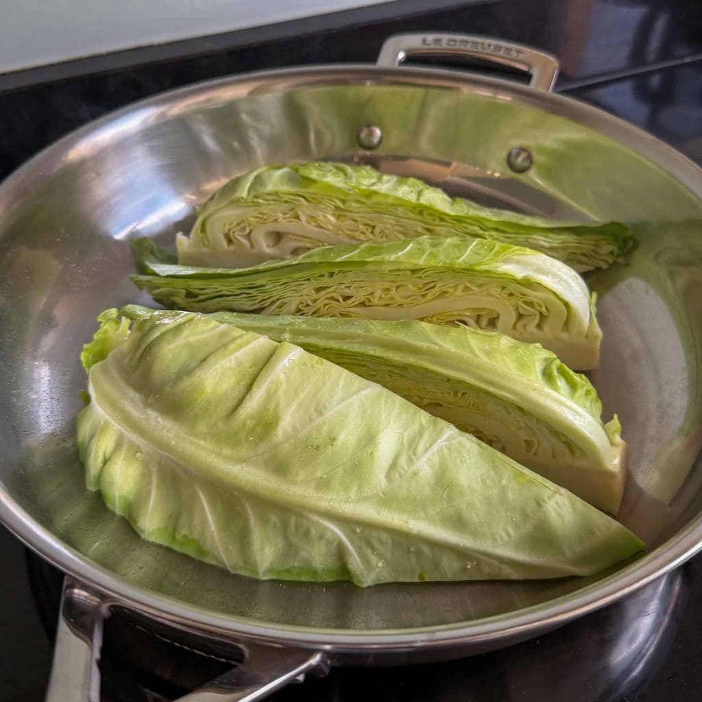 Charring the cabbage in a stainless steel frying pan.