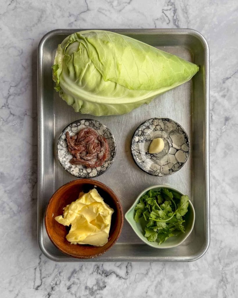 Ingredients used to make charred hispi cabbage with anchovy butter.