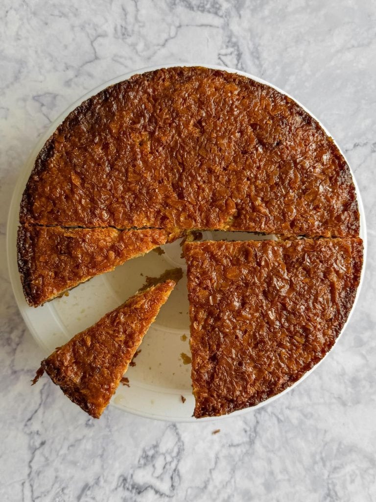 An overhead shot of the Earl Grey Portokalopita, with slices cut out.