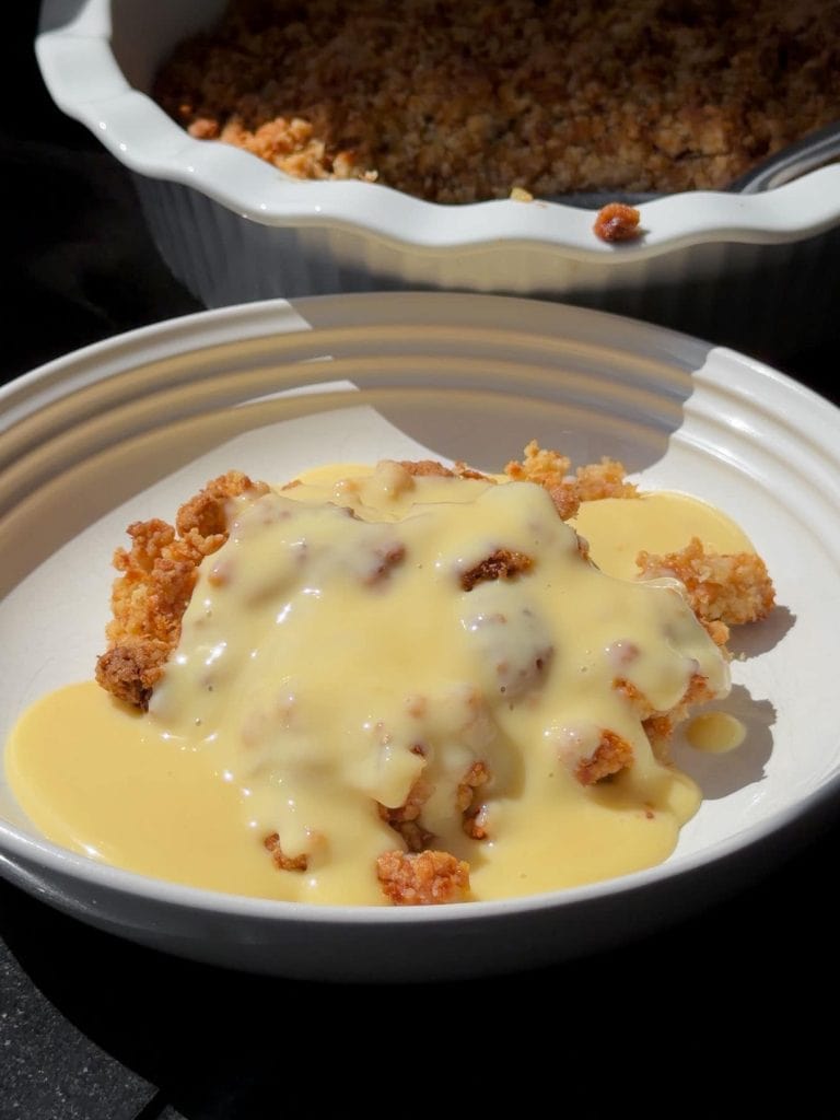 Almond croissant apple crumble, topped with custard.