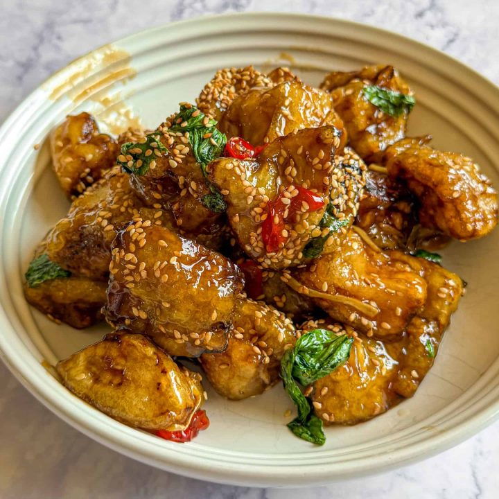 Crispy Thai aubergine tossed in a sticky savoury-sweet glaze with Thai basil and chilli