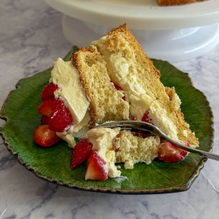 A closeup of the strawberry cloud cake with mascarpone cream, served on a green plate.