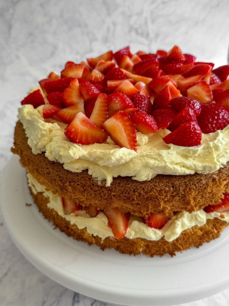 Strawberry cloud cake with mascarpone cream, served whole.