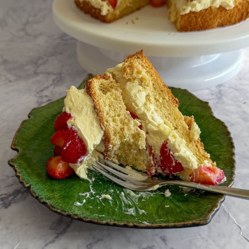 Strawberry cloud cake with mascarpone cream, served on a green plate.