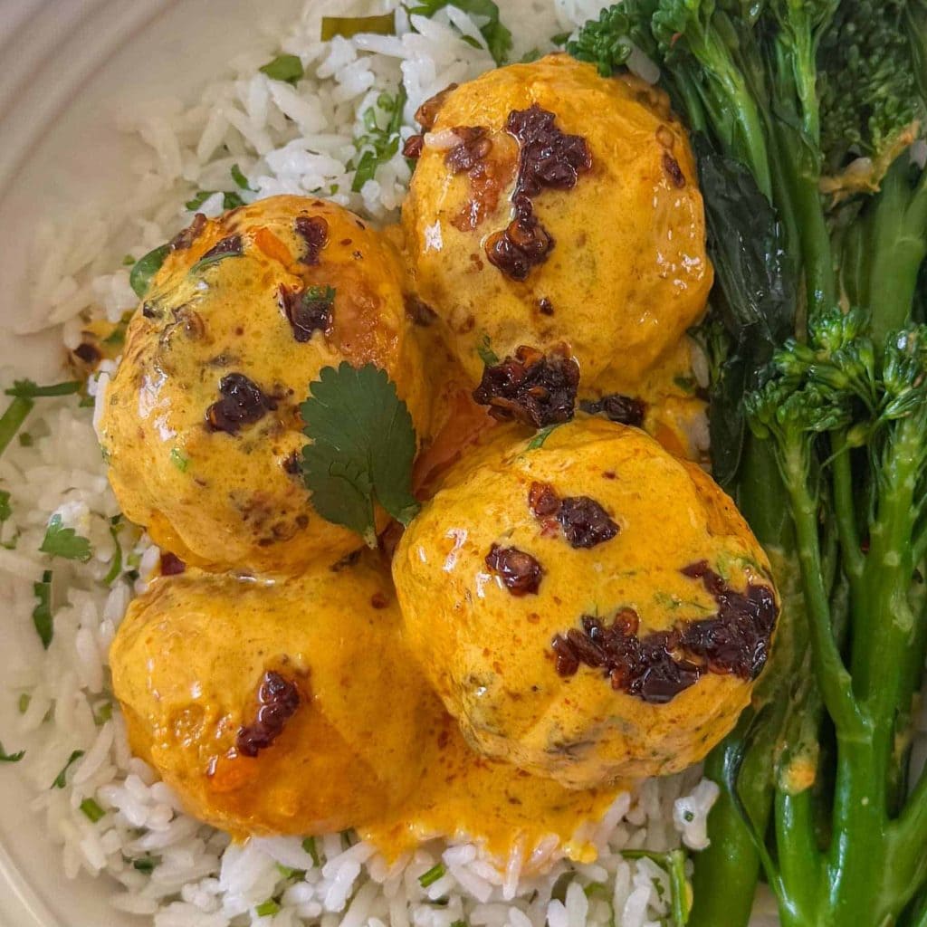 A close up of Thai curry chicken meatballs, served with sides