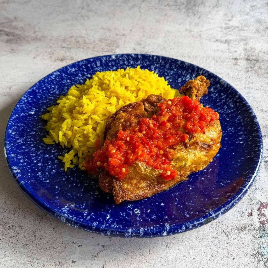 Ayam penyet, served with turmeric rice
