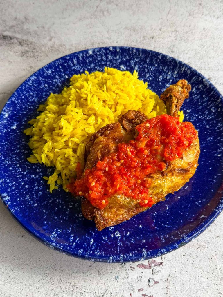 Crispy smashed Indonesian fried chicken, topped with sambal and served with rice