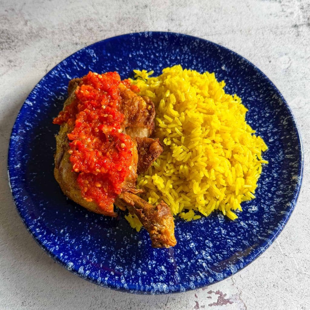 Indonesian smashed fried chicken with sambal and golden rice